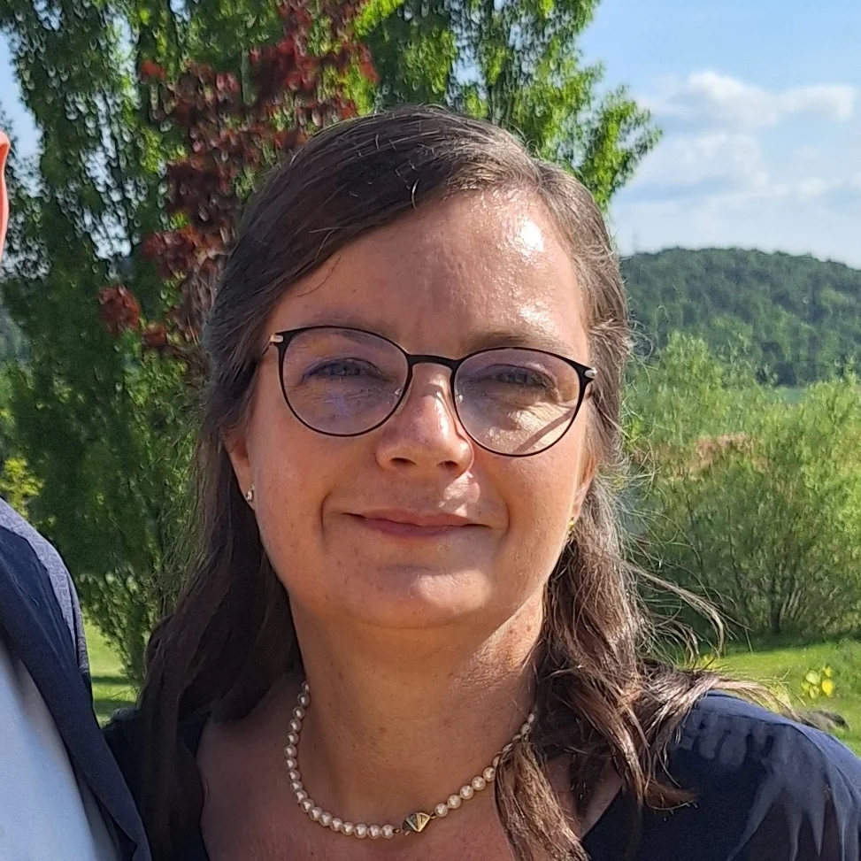a schoolbus in africa with many waving and smiling kids in front of it